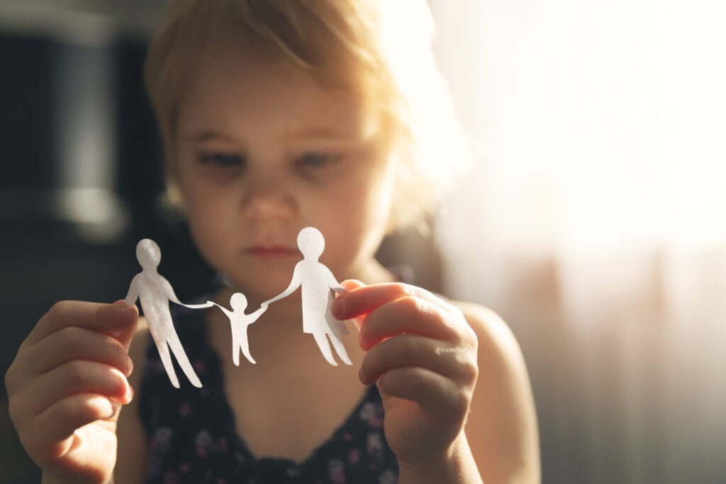 child looking at a family cutout